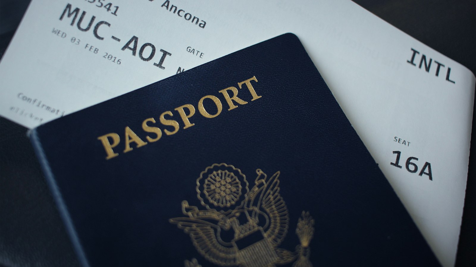 A passport booklet resting on top of white paper