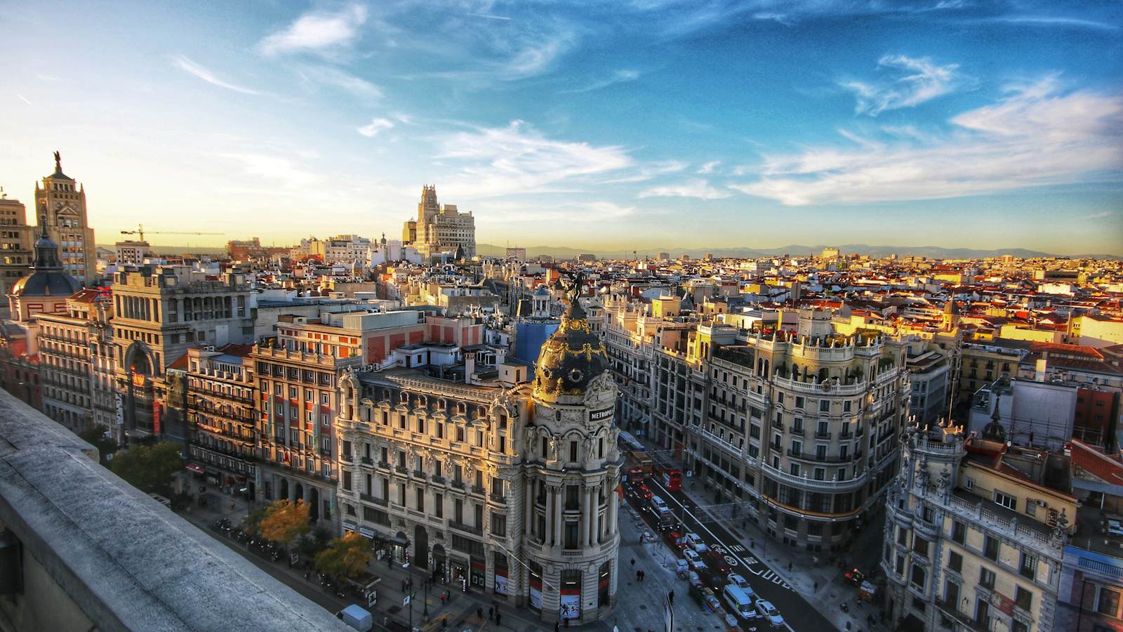 An aerial view of Gran Via and the Edificio Metropoli building in Madrid at sunset