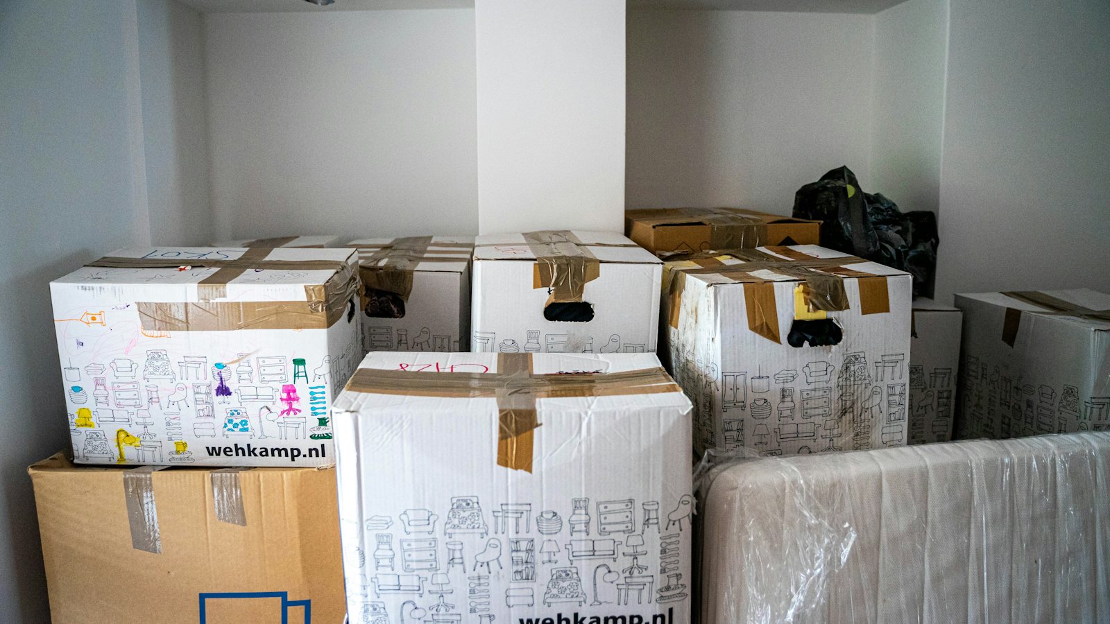 Brown cardboard moving boxes stacked on a wooden table